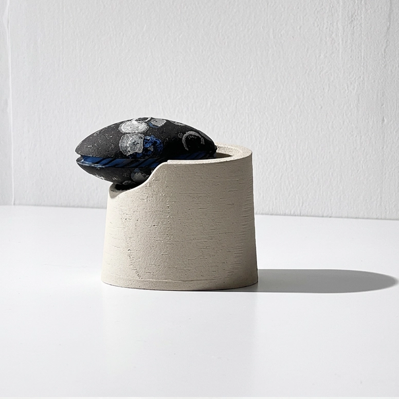 One 3D printed float box in wood-based filament with float lids with semi open lid.